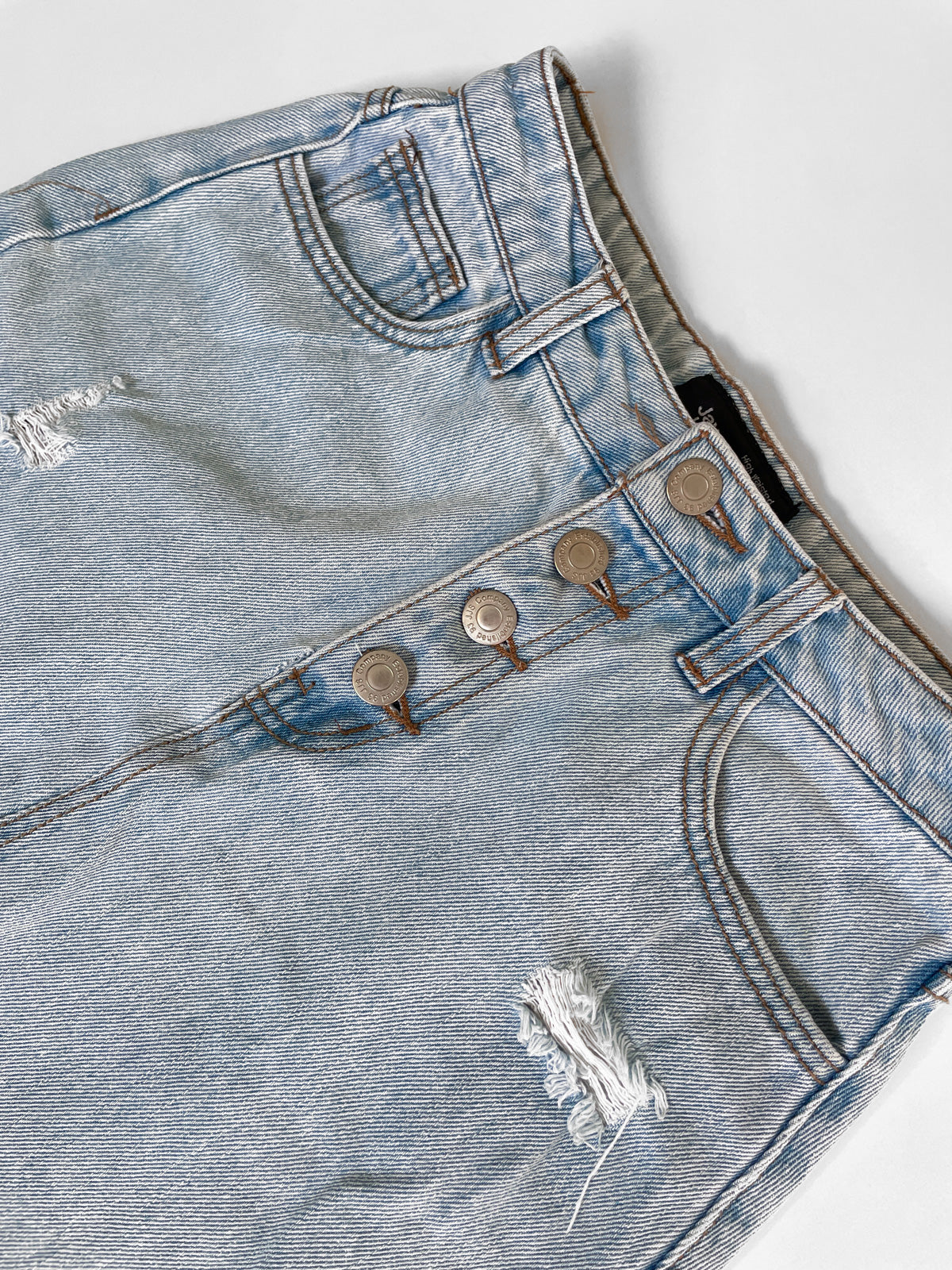 Distressed High Waisted Light Wash Denim Mini Skirt