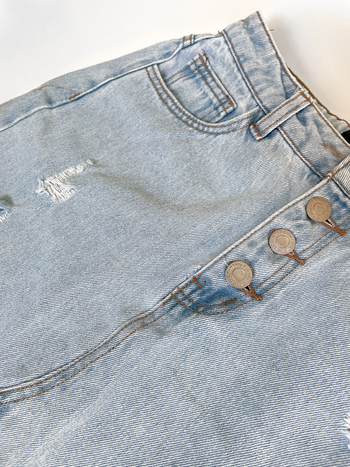 Distressed High Waisted Light Wash Denim Mini Skirt